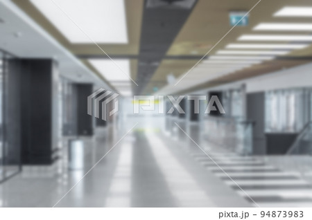 blurred background inside of modern administrative building or airport. indoor large corridor, hall. Inner passageway in office 94873983
