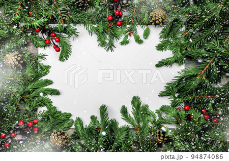 Christmas background with frosted fir tree. Snow Christmas composition with frame of fir branches and pine cones. Merry Christmas and happy New year. Christmas background with frosted fir tree. Snow Christmas composition with frame of fir branches and pine cones. Merry Christmas and happy New year. 94874086