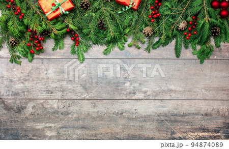 rustic wooden background with christmas ornaments. Christmas Holiday Evergreen Pine Branches and Red Berries Over Wood Background, Copy Space. Christmas rustic mockup rustic wooden background with christmas ornaments. Christmas Holiday Evergreen Pine Branches and Red Berries Over Wood Background, Copy Space. Christmas rustic mockup 94874089