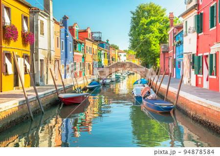 Burano island canal reflection, colorful houses and boats, Venetian lagoon Burano island canal reflection, colorful houses and boats, Venetian lagoon 94878584