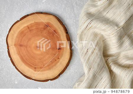 Cutting board and coasters on a gray concrete table with a kitchen towel. Food display template Cutting board and coasters on a gray concrete table with a kitchen towel. Food display template 94878679