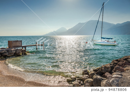 Idyllic lake Garda coastline in Malcesine with sailboats, Northern Italy 94878806