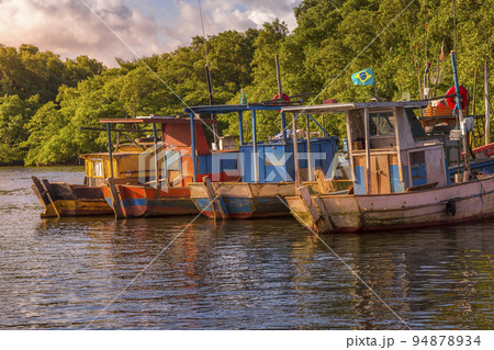 Bay at sunset with fishing trawler rustic boats in Porto Seguro, BAHIA, Brazil Bay at sunset with fishing trawler rustic boats in Porto Seguro, BAHIA, Brazil 94878934