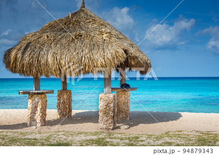 Aruba idyllic caribbean beach at sunny day with rustic palapa, Dutch Antilles 94879343