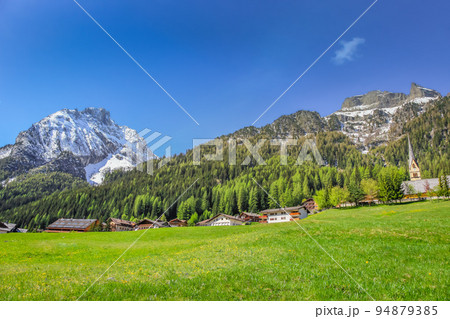 Village near Cortina D Ampezzo and alpine meadows with Dolomites alps, Italy Village near Cortina D Ampezzo and alpine meadows with Dolomites alps, Italy 94879385