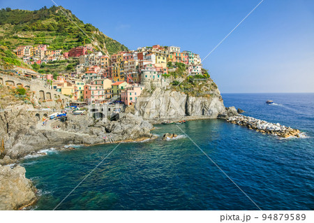 Manarola bay above cliffs, Cinque Terre, Liguria, Italy with boats Manarola bay above cliffs, Cinque Terre, Liguria, Italy with boats 94879589