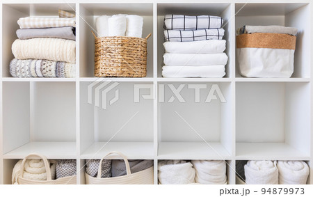 Bed linens closet neatly arrangement on shelves with copy space domestic textile Nordic minimalism 94879973