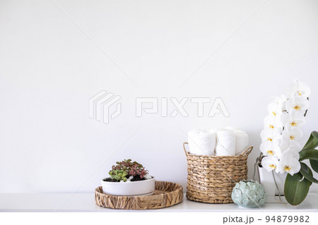 Potted plants in ecology straw baskets on shelf of bed linens cupboard textile arrangement storage 94879982