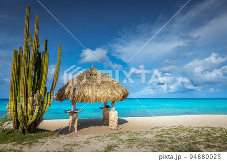 Aruba idyllic caribbean beach at sunny day with rustic palapa, Dutch Antilles Aruba idyllic caribbean beach at sunny day with rustic palapa, Dutch Antilles 94880025