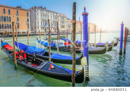 Ornate Gondolas in Grand Canal pier at sunrise, Venice, Italy 94880051