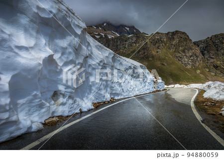 Alpine mountain road between snow at springtime, Gran Paradiso Alps, Italy Alpine mountain road between snow at springtime, Gran Paradiso Alps, Italy 94880059