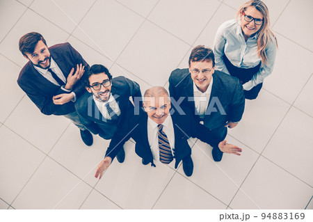 top view. a group of happy business people looking at the camera. 94883169
