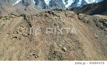 Mountain pass with steep descent and rocks Mountain pass with steep descent and rocks 94884459