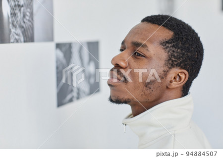 Man Looking at pictures in Gallery Closeup 94884507