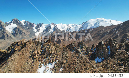Rocky pass with a view of the snowy mountains Rocky pass with a view of the snowy mountains 94884524