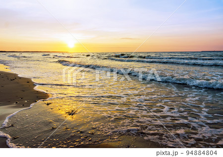 Sunset over the sea. Reflection of sunlight in the sea waves. The sky in the sunset rays. Sunset over the sea. Reflection of sunlight in the sea waves. The sky in the sunset rays. 94884804