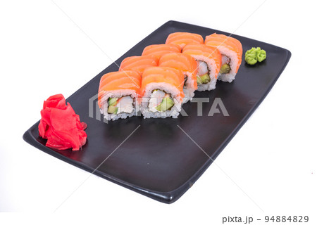 Japanese seafood Sushi roll isolated on white close up. Japanese food restaurant, sushi maki gunkan roll plate or platter set. Maki Sushi rolls with salmon and avocado. Sushi isolated at white 94884829