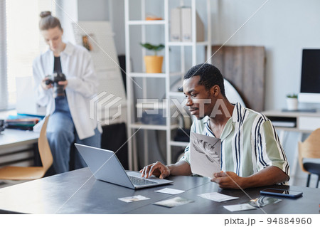 Young Black Photographer Using Laptop Young Black Photographer Using Laptop 94884960