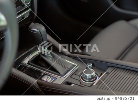 Close up of automatic gear lever of new car in dealership Close up of automatic gear lever of new car in dealership 94885701