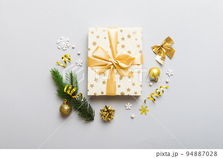 Top view Flat lay Christmas decorations and gift box on colored background with copy space. Christmas or Happy New Year composition Top view Flat lay Christmas decorations and gift box on colored background with copy space. Christmas or Happy New Year composition 94887028