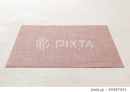 Perspective view of red tablecloth for food on cement background. Empty space for your design 94887091