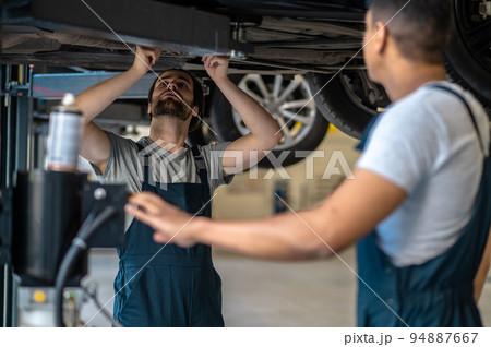 Auto repair service staff inspecting the client vehicle 94887667