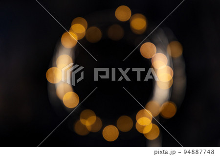 Fairy lights, blurred frame on a black background, abstract Christmas banner Fairy lights, blurred frame on a black background, abstract Christmas banner 94887748