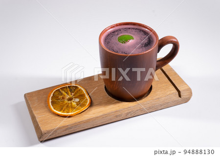 hot cup of mulled red wine, citrus dry orange on wooden board isolated on white hot cup of mulled red wine, citrus dry orange on wooden board isolated on white 94888130