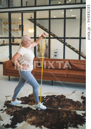 Mature plus-size woman working out at home 94888285