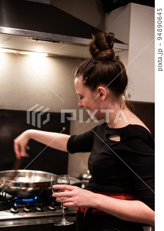Attractive woman cooking in her kitchen 94890645