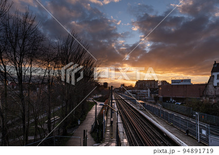 Laken, Brussels Capital Region - Belgium - Colorful clouds over the railway tracks at the local metro and train stop Pannenhuis - Tour and Taxis 94891719