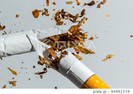 Broken cigarette fly in air on a light background. Conception of combating smoking 94892259