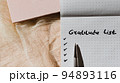 Close-up of notebook or personal diary with handwritten text "Gratitude list", pen. Wellness. Selfcare. Gratitude journal. Mindfulness practice. Selective focus. 94893116