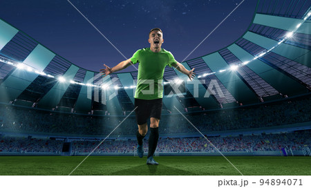 Winner emotions. Excited soccer player running at the crowded stadium with spot lights during evening football match. Concept of sport, competition, championship 94894071