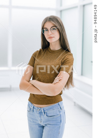smiling young woman standing in bright office . smiling young woman standing in bright office . 94894149