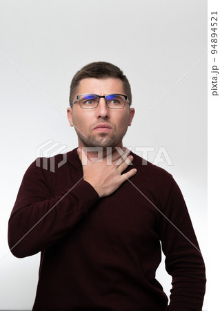 Handsome man wearing glasses over isolated background touching painful neck, sore throat from flu, cold and infection Handsome man wearing glasses over isolated background touching painful neck, sore throat from flu, cold and infection 94894521