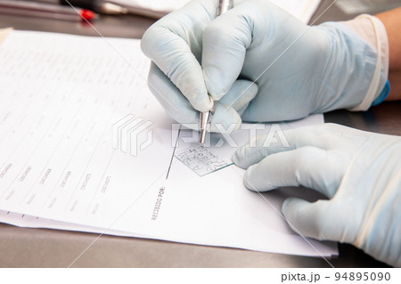 Laboratorian giving admission to pap smear samples in the laboratory for analysis. Scientist receiving patient samples for laboratory for analysis. Cervical cancer concept. Medical concept. 94895090