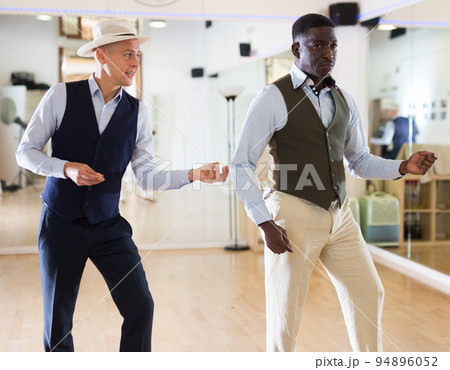 Two men dancing jazz in studio Two men dancing jazz in studio 94896052