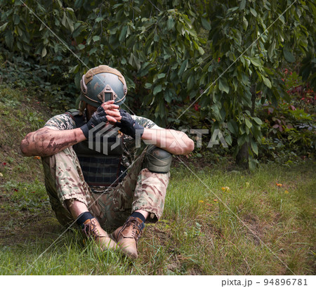 Sad soldier sits on the ground Sad soldier sits on the ground 94896781