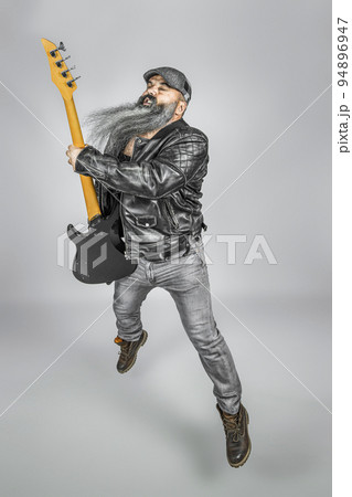 rocker with guitar and long beard 94896947