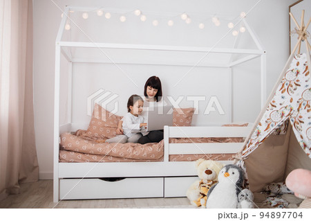 Happy cute daughter and young mother have online video call with father or grandmother using laptop 94897704