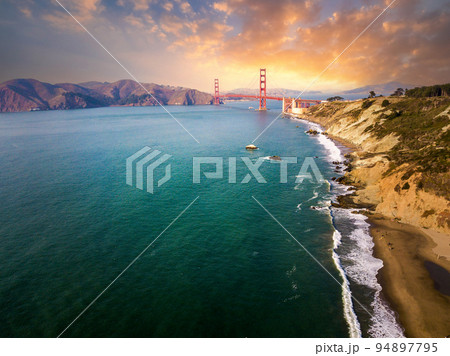 Sunset over Golden Gate bridge seen from Marshall's beach in San Francisco Sunset over Golden Gate bridge seen from Marshall's beach in San Francisco 94897795