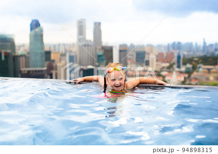 Kids swim in Singapore roof top swimming pool 94898315