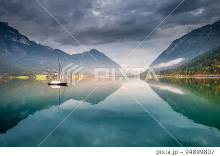 Sailboats in Achensee lake near Innsbruck at peaceful dawn, Tyrol alps, Austria 94899807