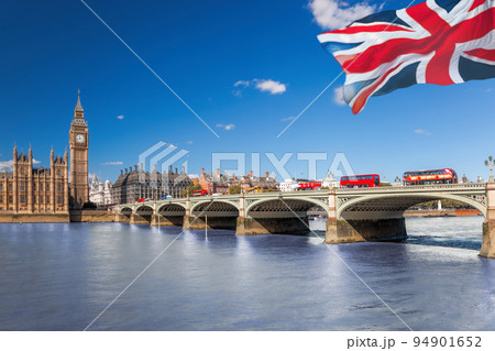 Famous Big Ben with red buses on bridge over Thames river in London, England, UK 94901652