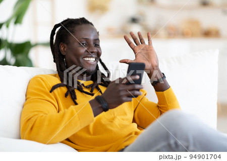 Distant Communication. Smiling Black Guy Making Video Call Via Smartphone At Home 94901704