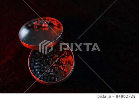 air gun pellets on darck cloth background with red light for illumination air gun pellets on darck cloth background with red light for illumination 94902728