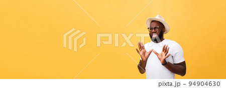Closeup portrait of shocked mad young man raising hand up to say no stop right there, isolated on yellow background. Negative emotion facial expression feelings, signs symbols, body language. Closeup portrait of shocked mad young man raising hand up to say no stop right there, isolated on yellow background. Negative emotion facial expression feelings, signs symbols, body language. 94904630