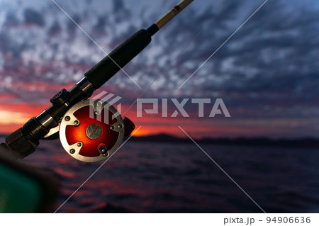 Deep Sea Fishing Reel on a boat during sunrise Deep Sea Fishing Reel on a boat during sunrise 94906636