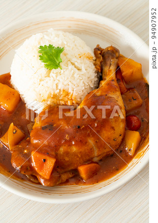 chicken stew with tomatoes, onions, carrot and potatoes on plate with rice chicken stew with tomatoes, onions, carrot and potatoes on plate with rice 94907952